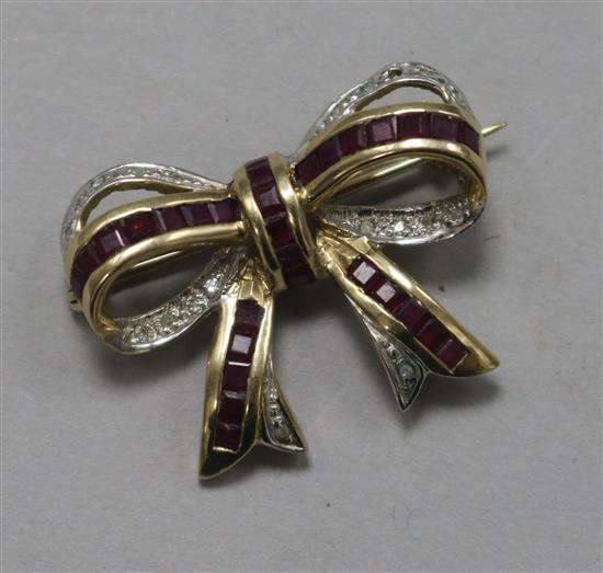 A 9ct gold ruby and diamond set ribbon bow brooch, 27mm.